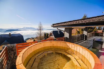 a wooden spiral staircase on a balcony of a house at Holiday Home Mountainview Horizon with Private Sauna & Hot Tub in Dravograd