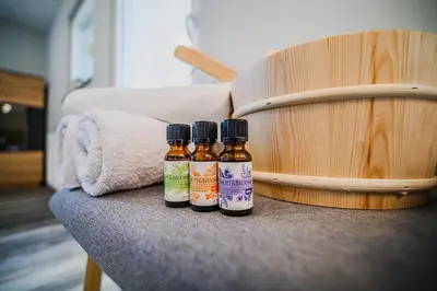 three bottles of soy sauce next to a wooden barrel at Holiday Home Mountainview Horizon with Private Sauna & Hot Tub in Dravograd