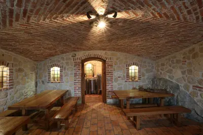 a room with wooden tables and a ceiling fan at Holiday home in Otocec - Kranjska (Krain) 33898 in Otočec