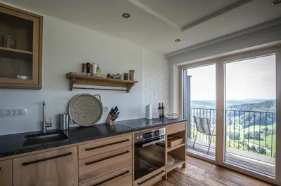 a kitchen with a counter top and a balcony at Winzarei Ciringa Stampfer in Svečina