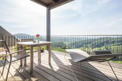 a balcony with a table and chairs and a view at Winzarei Ciringa Stampfer in Svečina