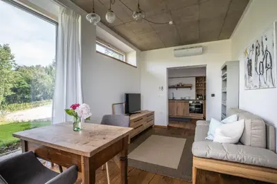a living room with a table and a couch at Winzarei Ciringa Stampfer in Svečina