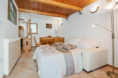 a bedroom with a large bed and a table at Hiška Kovačija in Vremski Britof