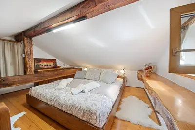 a bedroom with a bed in a attic at Hiška Kovačija in Vremski Britof