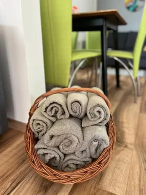 a basket filled with towels sitting on a floor at House of Eden- Private Family Holiday Home in Terme Catez with FREE Pool Tickets in Čatež ob Savi