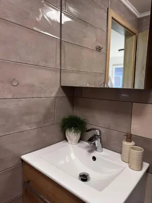 a bathroom with a sink and a mirror at House of Eden- Private Family Holiday Home in Terme Catez with FREE Pool Tickets in Čatež ob Savi