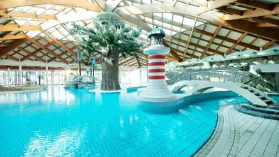 a large swimming pool with a lighthouse in a building at House of Eden- Private Family Holiday Home in Terme Catez with FREE Pool Tickets in Čatež ob Savi