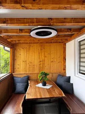 a room with a wooden table and a potted plant at House of Eden- Private Family Holiday Home in Terme Catez with FREE Pool Tickets in Čatež ob Savi