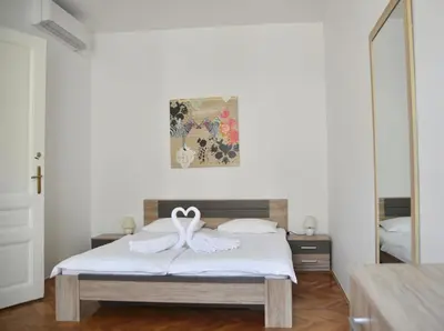 a bedroom with a bed with a bow on it at Apartment Trdinova in Ljubljana