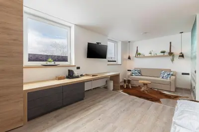 a living room with a television and a couch at Apartments Tabor in Naklo