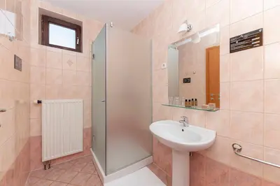 a bathroom with a sink and a shower at Apartments Tabor in Naklo