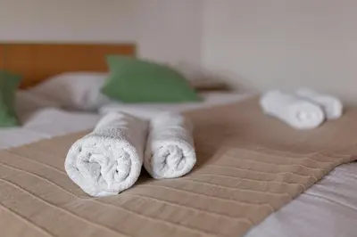 a group of rolled towels on a bed at Apartments Tabor in Naklo