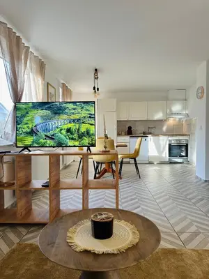 a living room with a table with a monitor on it at Montis Bled in Bled