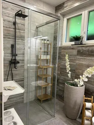 a shower stall with a glass door in a bathroom at Studio Belaj in Celje