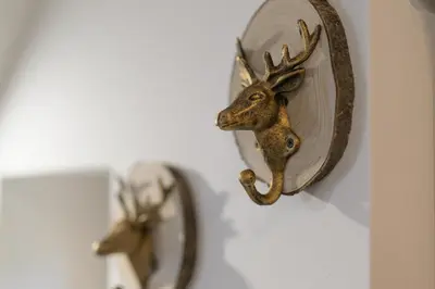 a mirror with a deer head on a wall at Dovski Razgled in Dovje
