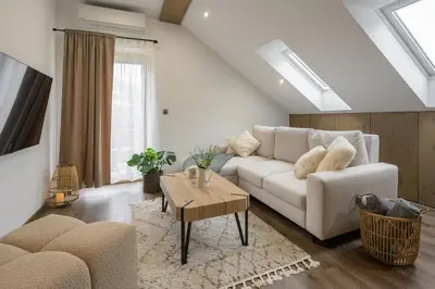 a living room with a white couch and a table at Dovski Razgled in Dovje