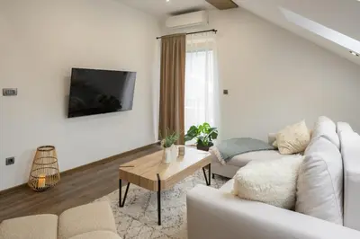 a white living room with a white couch and a table at Dovski Razgled in Dovje
