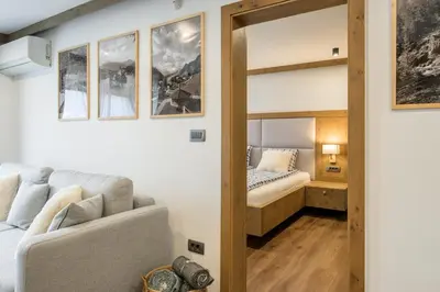 a room with a bed and a couch and a mirror at Dovski Razgled in Dovje
