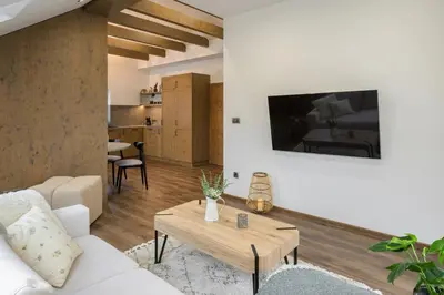 a living room with a white couch and a table at Dovski Razgled in Dovje