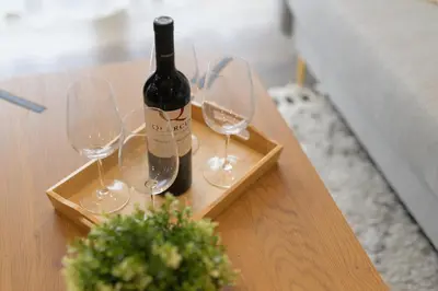 a bottle of wine and two wine glasses on a table at Dovski Razgled in Dovje