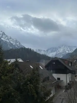 a town with snow capped mountains in the background at Kranjska Gora Urban Apartment in Kranjska Gora