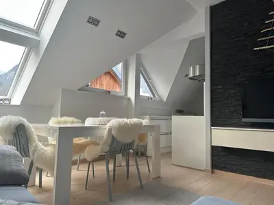 a kitchen and dining room with a table and chairs at Kranjska Gora Urban Apartment in Kranjska Gora