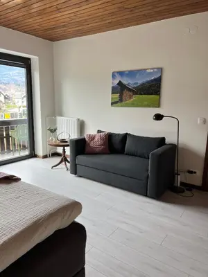 a living room with a couch and a window at Orchard Villa in Bled