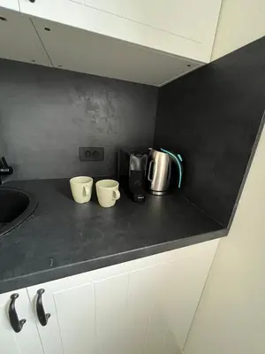 a kitchen counter with two coffee cups on it at Orchard Villa in Bled