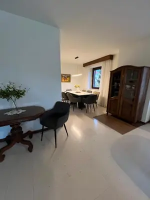 a living room with a table and a dining room at Orchard Villa in Bled