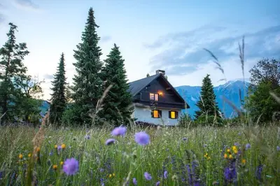 a house in the middle of a field of flowers at Orchard Villa in Bled