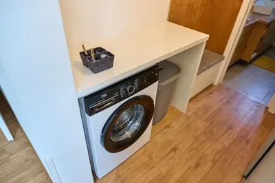 a washer and dryer under a counter in a room at Chili apartment in Žabnica