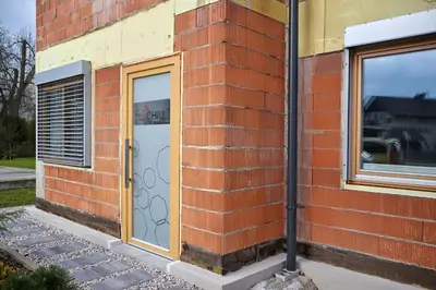 a brick building with a door and windows at Chili apartment in Žabnica