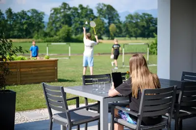 a woman sitting at a table playing a game of baseball at Chili apartment in Žabnica