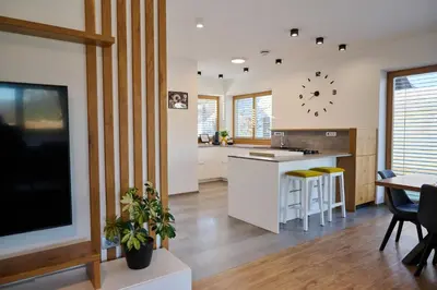 a kitchen with a large clock on the wall at Chili apartment in Žabnica
