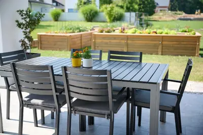 a wooden table and chairs on a patio at Chili apartment in Žabnica