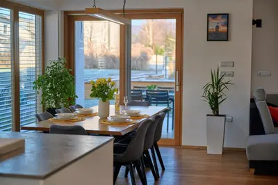 a dining room with a table and chairs in a room at Chili apartment in Žabnica