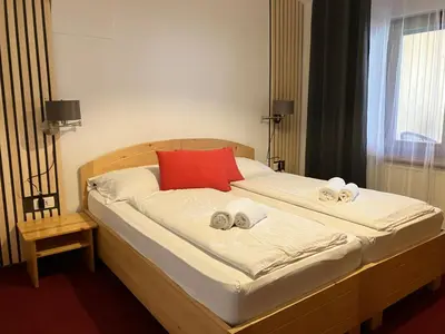 a bedroom with a bed with towels on it at Apartments Pri Boštjanovcu in Gorenja Vas