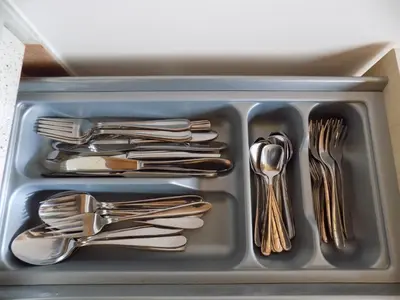 a tray of silver utensils in a drawer at Apartment Zeleni dragulj Pohorje, mir & čudovita narava in Oplotnica