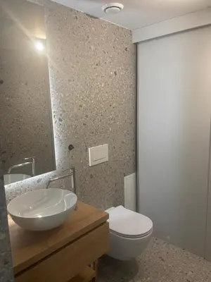 a bathroom with a sink and a toilet and a mirror at Vila Solini in Kozana