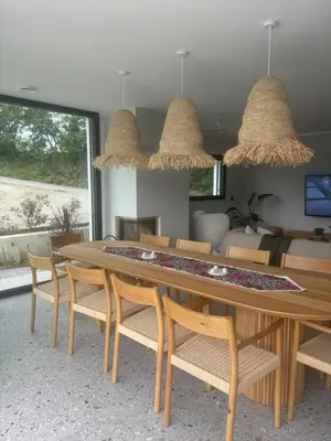 a dining room with a wooden table and chairs at Vila Solini in Kozana