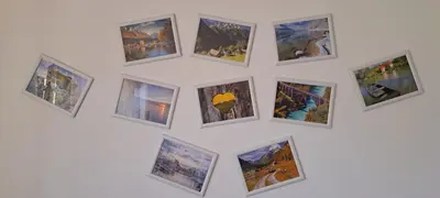 a group of pictures on a white wall at Biba House in Tolmin