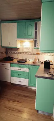 a kitchen with green and white cabinets and wooden floors at La Vita House Camp Terme 3000 Moravske Toplice 2 Thermal Tickets Included Free Bikes in Moravske Toplice