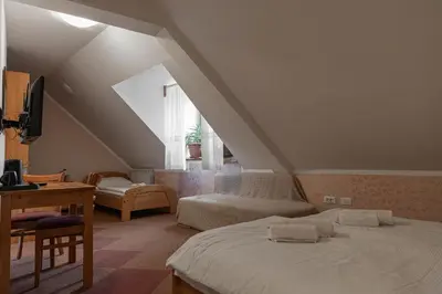 a bedroom with two beds and a desk and a window at Martinov Hram in Bovec