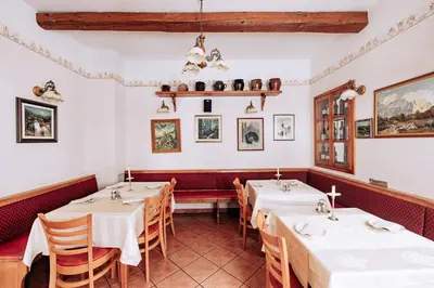 a restaurant with tables and chairs in a room at Martinov Hram in Bovec