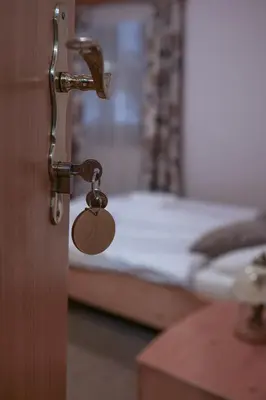 a door handle with a key in a room with a bed at Martinov Hram in Bovec
