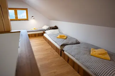 a room with two beds with yellow pillows on them at Pr Štepiherju in Luče