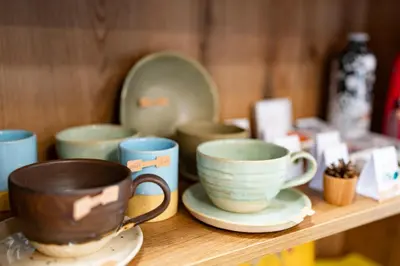 a wooden shelf with cups and plates on it at Pr Štepiherju in Luče