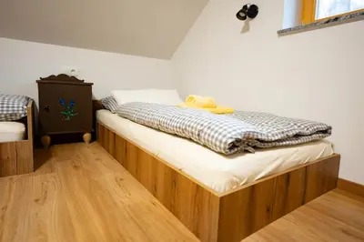 a bedroom with a bed with a teddy bear on it at Pr Štepiherju in Luče