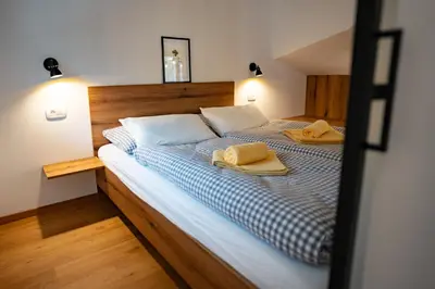 a bedroom with a bed with two towels on it at Pr Štepiherju in Luče