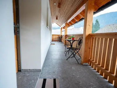 a porch of a house with a table and chairs at Pr Štepiherju in Luče